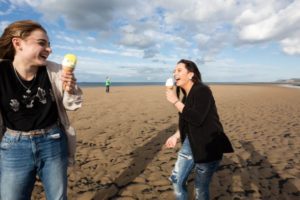 Two people visiting Redcar beach to enjoy a lemon top